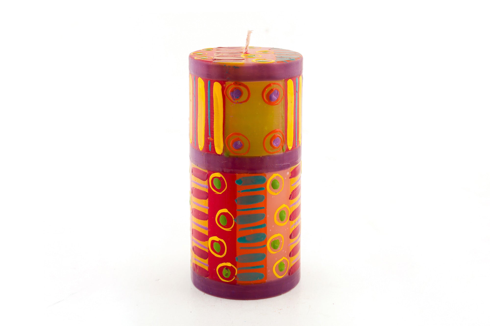 Carousel 3x6 pillar candle. Dots, stripes and circles in pinks, purple, yellow, red, & greens.