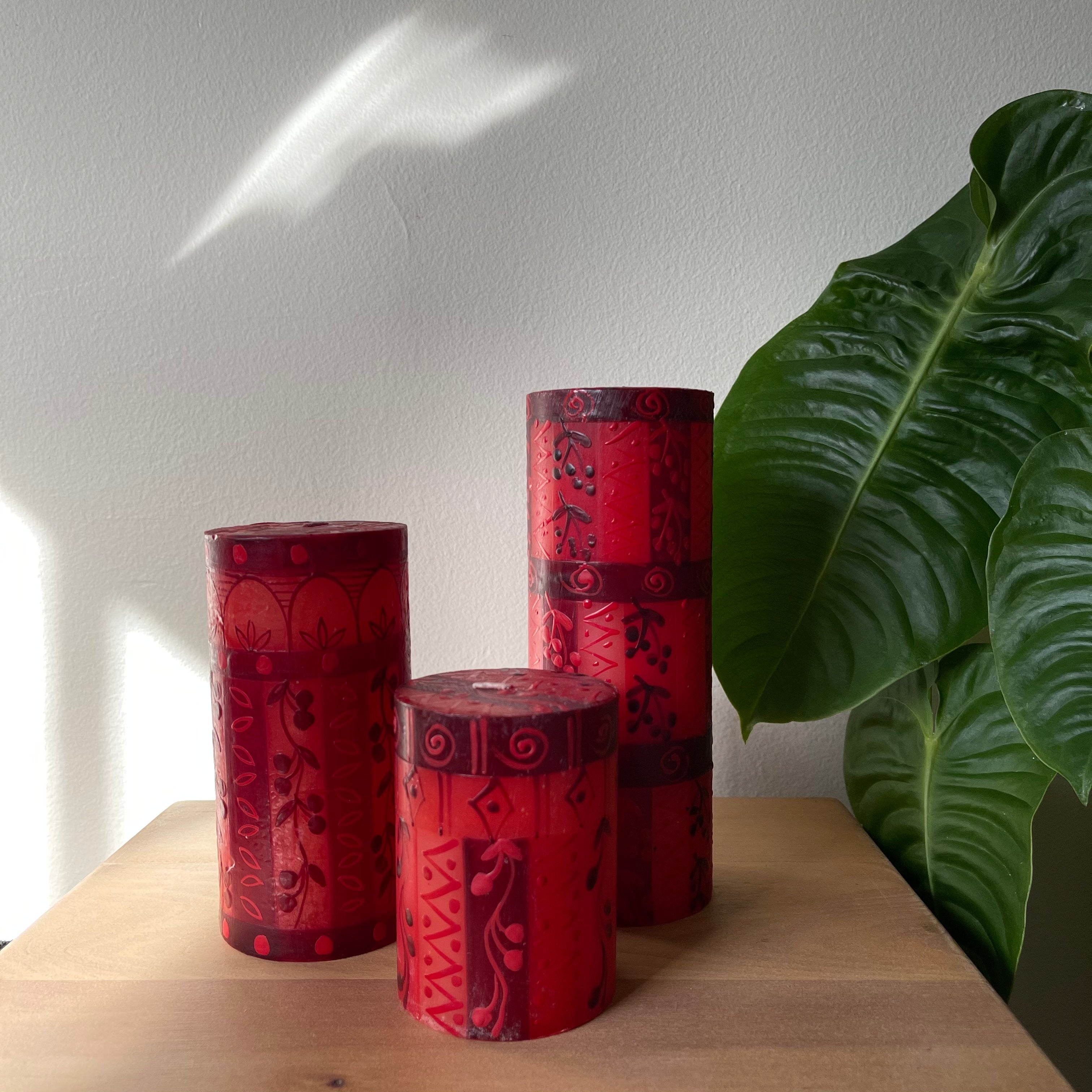 Three Berry Blaze pillars.  3x4, 3x6, and 3x8 inches.  Hand painted in hews of red with a berry pattern.