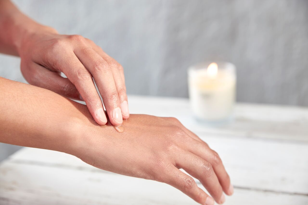 Applying warm soy wax to hands. The soy wax is a very good moisturizer for hands and feet.