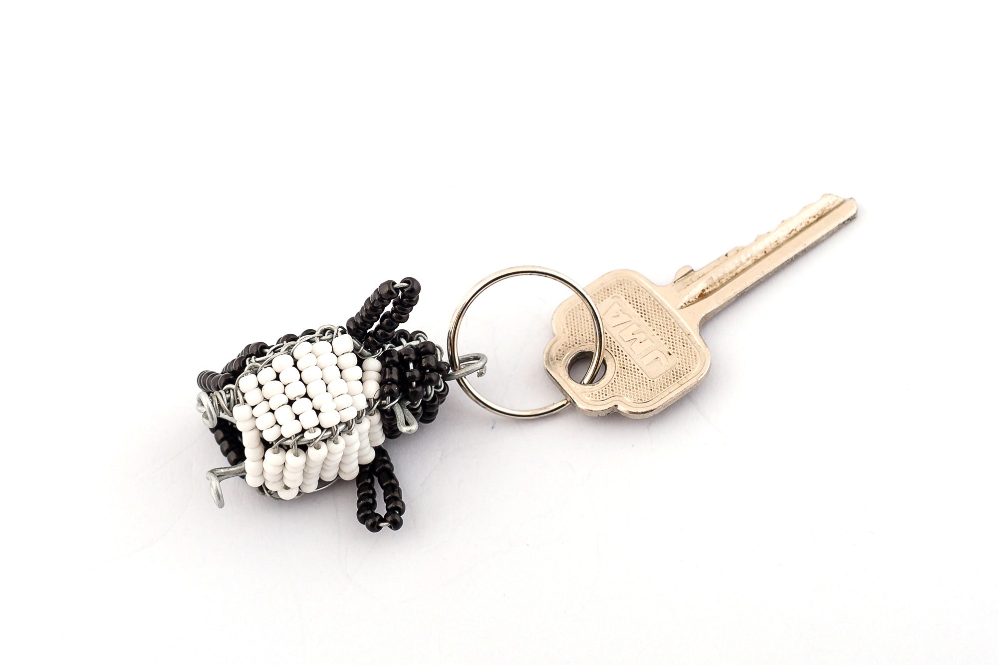 Beaded penguin key chain. Handmade with a beaded black back and white tummy - just like the tuxedo that a penguin wears!  So cute!