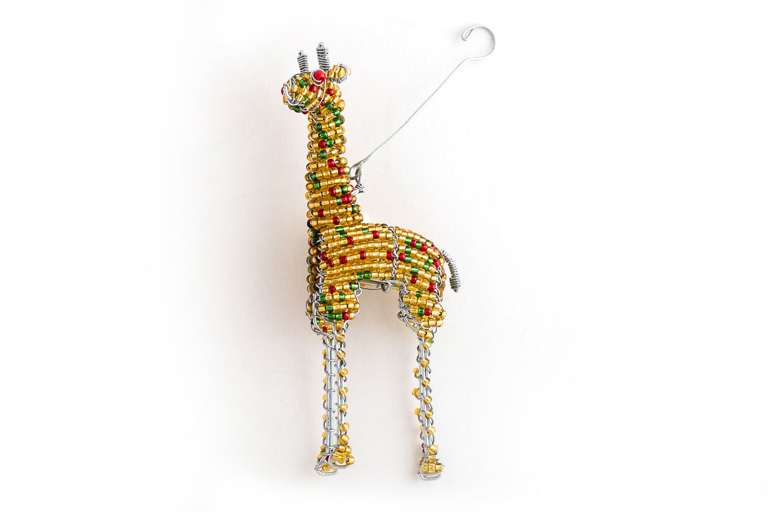 Golden yellow hand made beaded giraffe that is a Christmas ornament. Comes in a gift box with an elephant and hippo.