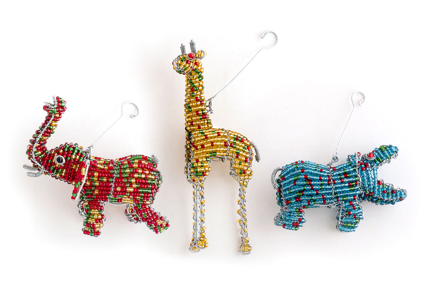 Wonderful African Beaded animals for your Christmas tree, Come is a gift set of 3; hippo, elephant and giraffe. Colorful, and each with hanger for the tree.