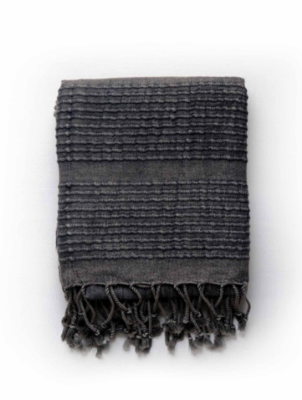 Folded grey-black stone washed towel with tie fringe.