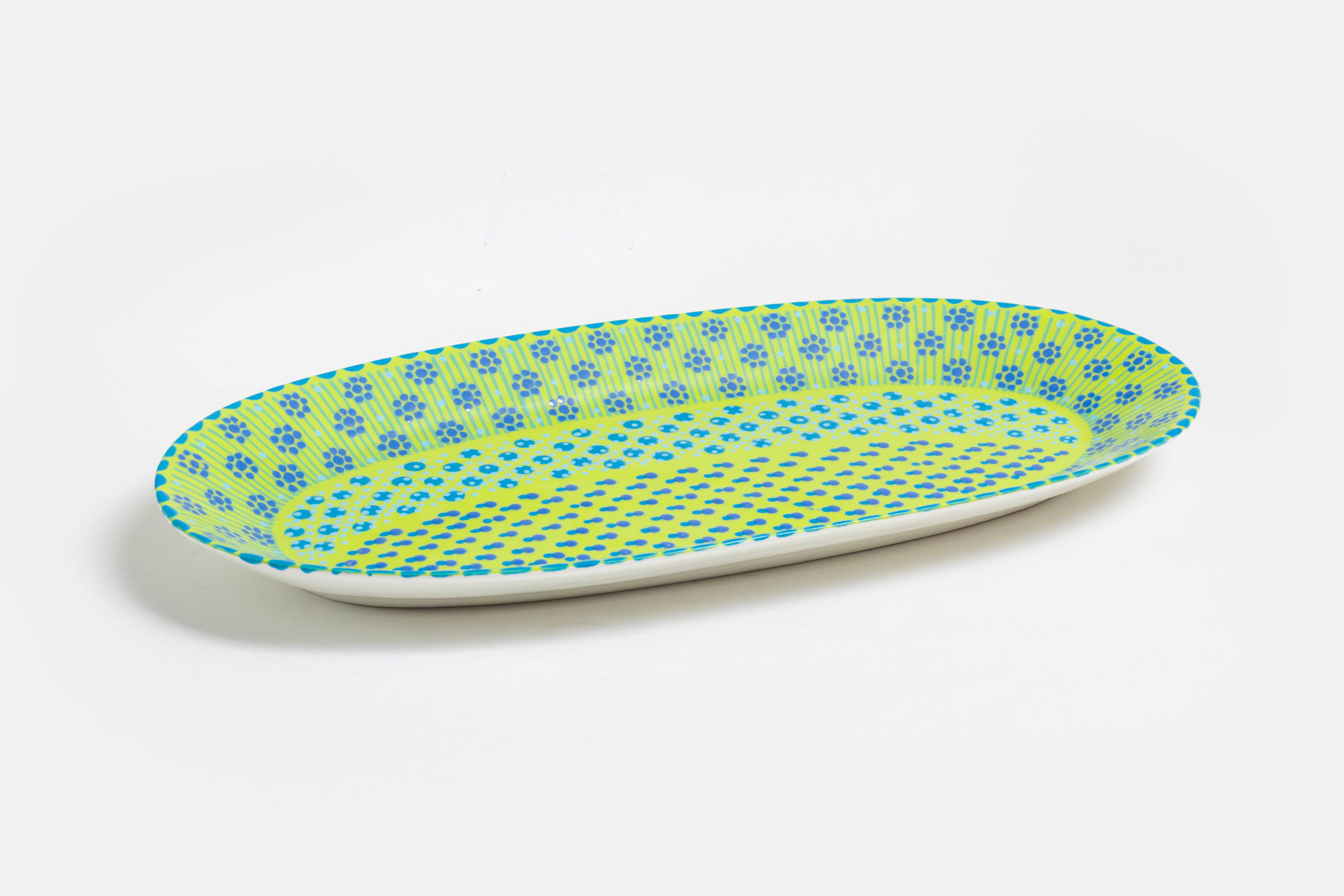 Serving platter with lime green base color, painted with dots, stripes and flowers in indigo, orange, yellow, and baby blue.  Microwave and dishwasher safe.
