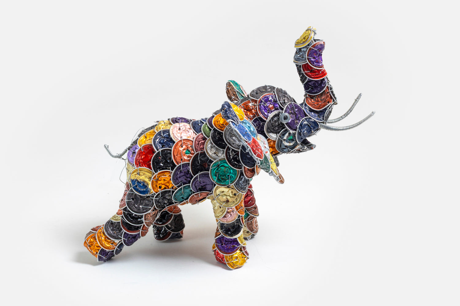 Elephant made from colorful upcycled coffee pods; cleaned, smashed and strung together to make this wonderful whimsy elephant.  Truck up for Good Luck!