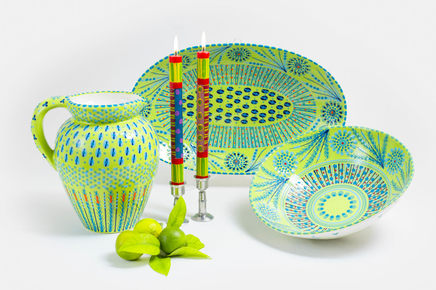 Wonderful lime green water jug, large oval serving bow, and large round serving bowl along side a water jug and pair of carousel taper pairs. Lovely collection!