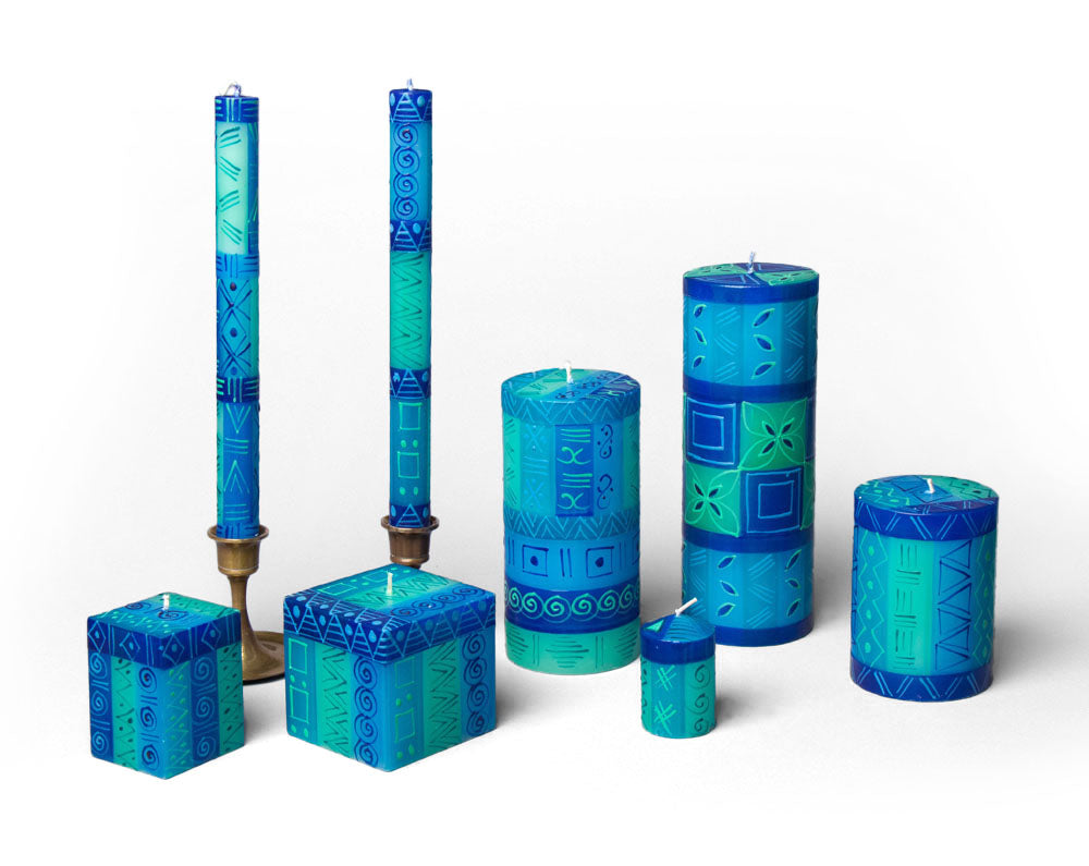 Blue & Green hand made & hand painted candle collection. Two sizes of cubes, taper candle pair, 3 sizes of pillar candles, and votives. All painted in a blue & green pattern.