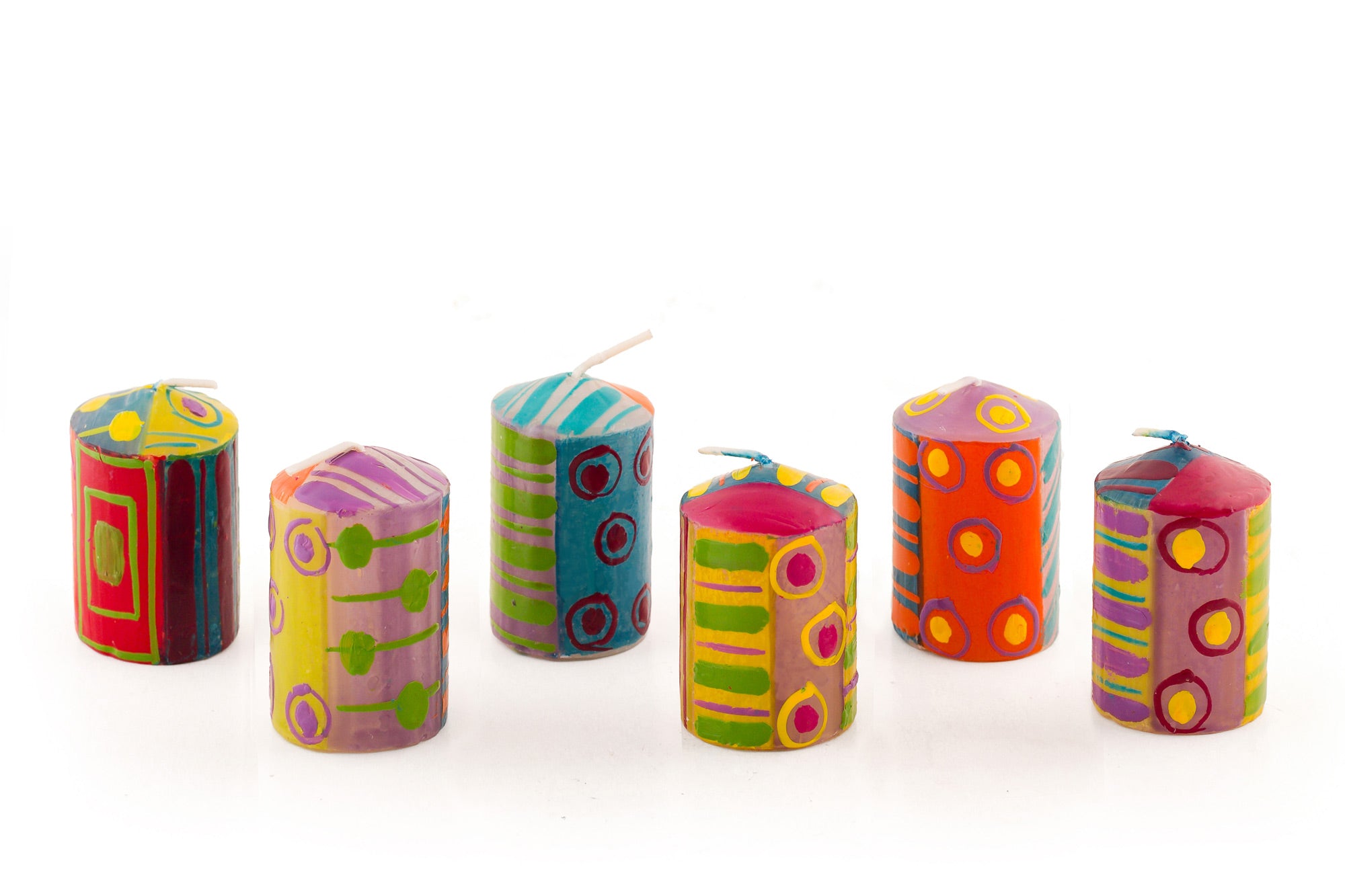 Six Carousel 2" votive candles in various designs. Dots, stripes and circles in pinks, purple, yellow, red, greens and turquoise! The 6 votives come in a gift pack.