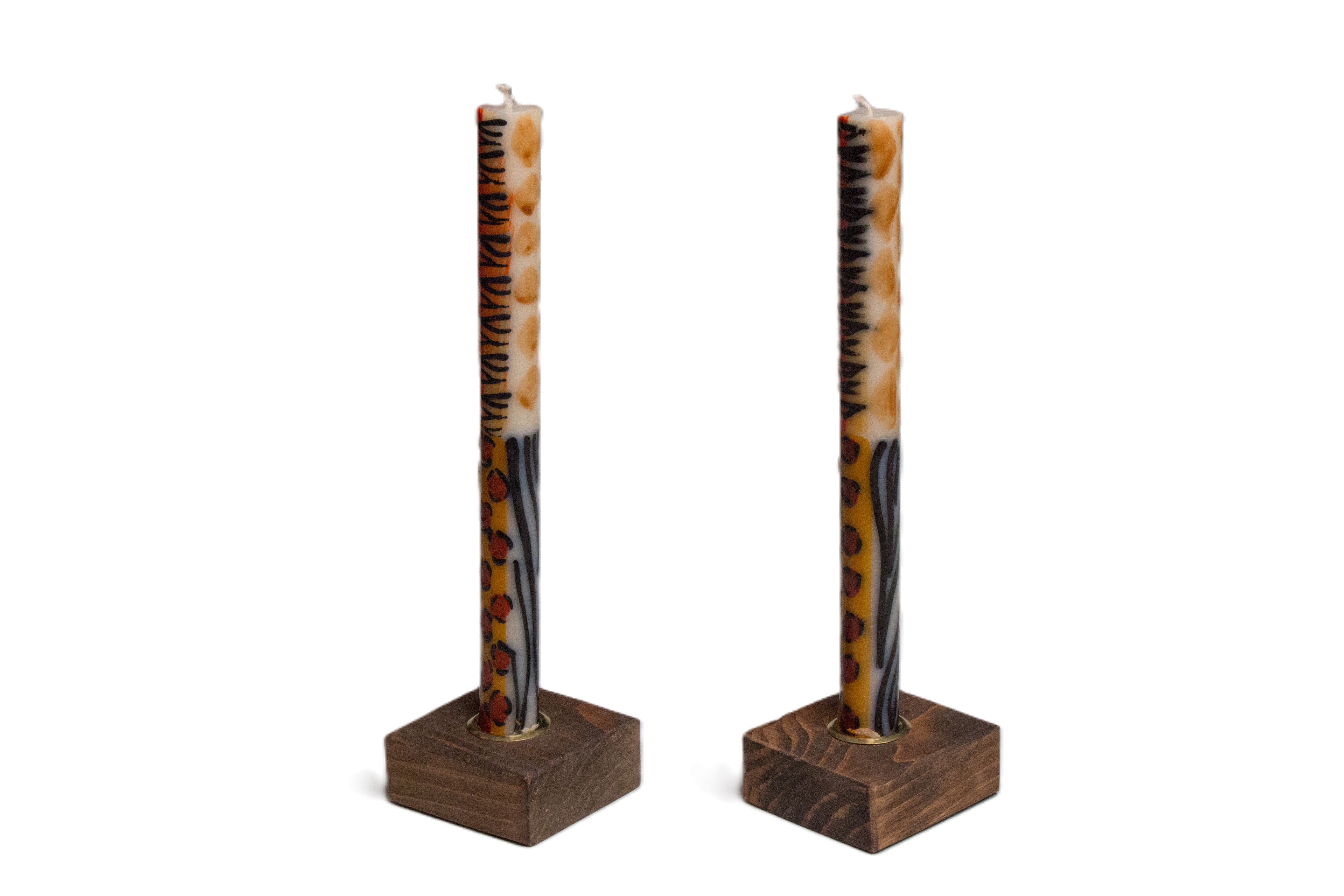 Dark color wooden taper candle holders holding a pair of Animal Print taper candles!
