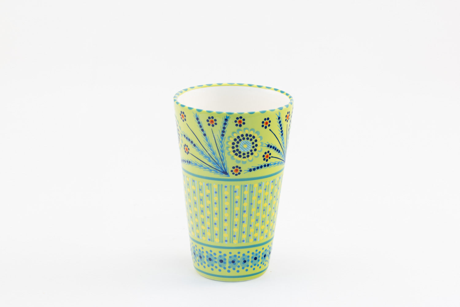 Ceramic vase with background color of lime green.  Dots, stripe and flowers make the colorful designs on the background colors. 8.8" tall x 5.5" wide.