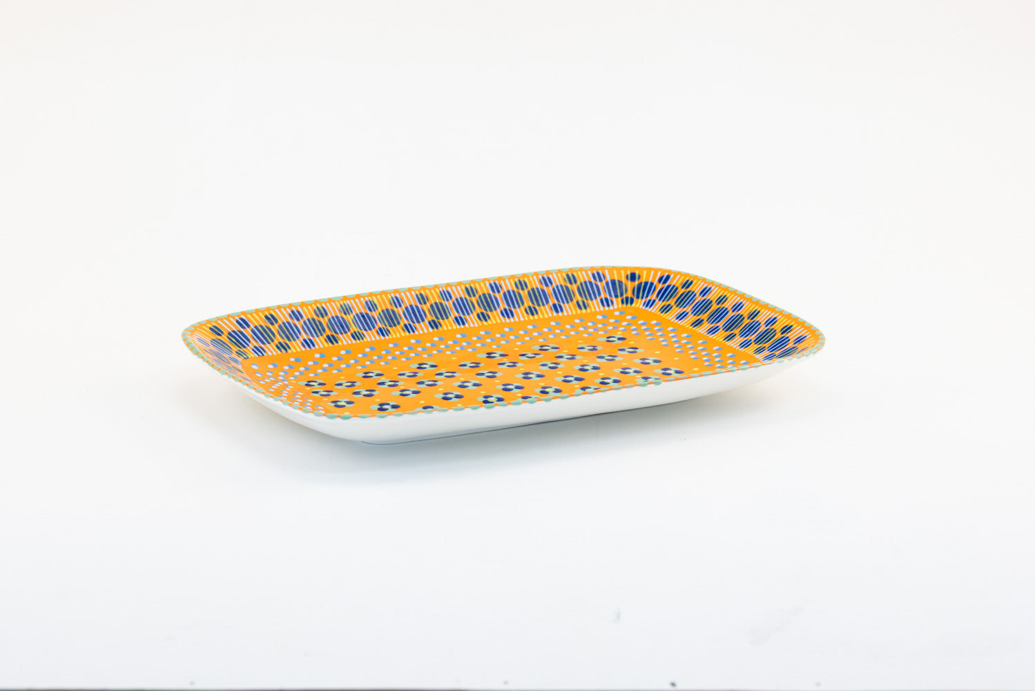 Colorful, ceramic and versatile serving platter. Microwave & dishwasher safe.  15" x 10".  Base color of orange. Dots & Stripes and flowers are painted on top in red, yellow, Lime Green, and indigo. Such an eye-catcher!