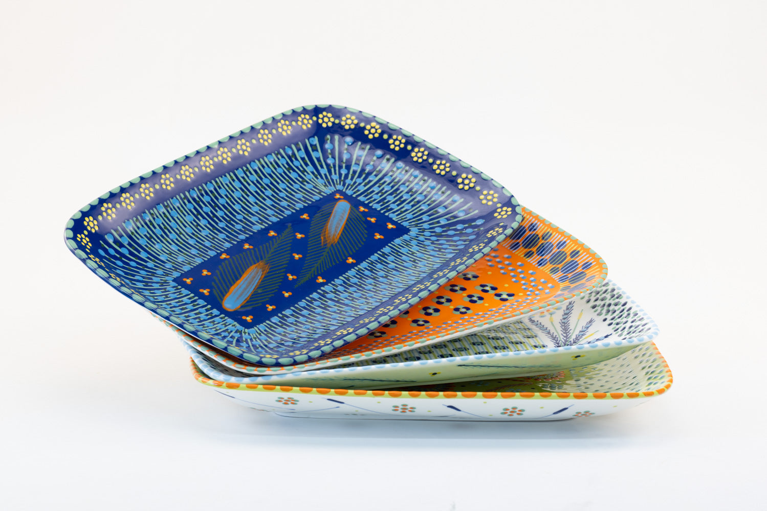 Colorful, ceramic and versatile serving platters. Microwave & dishwasher safe.  15" x 10".  Base colors of Indigo blue, orange, white and Lime green. Dots & Stripes and flowers are painted on top in red, yellow, Lime Green, and orange. Such an eye-catcher!