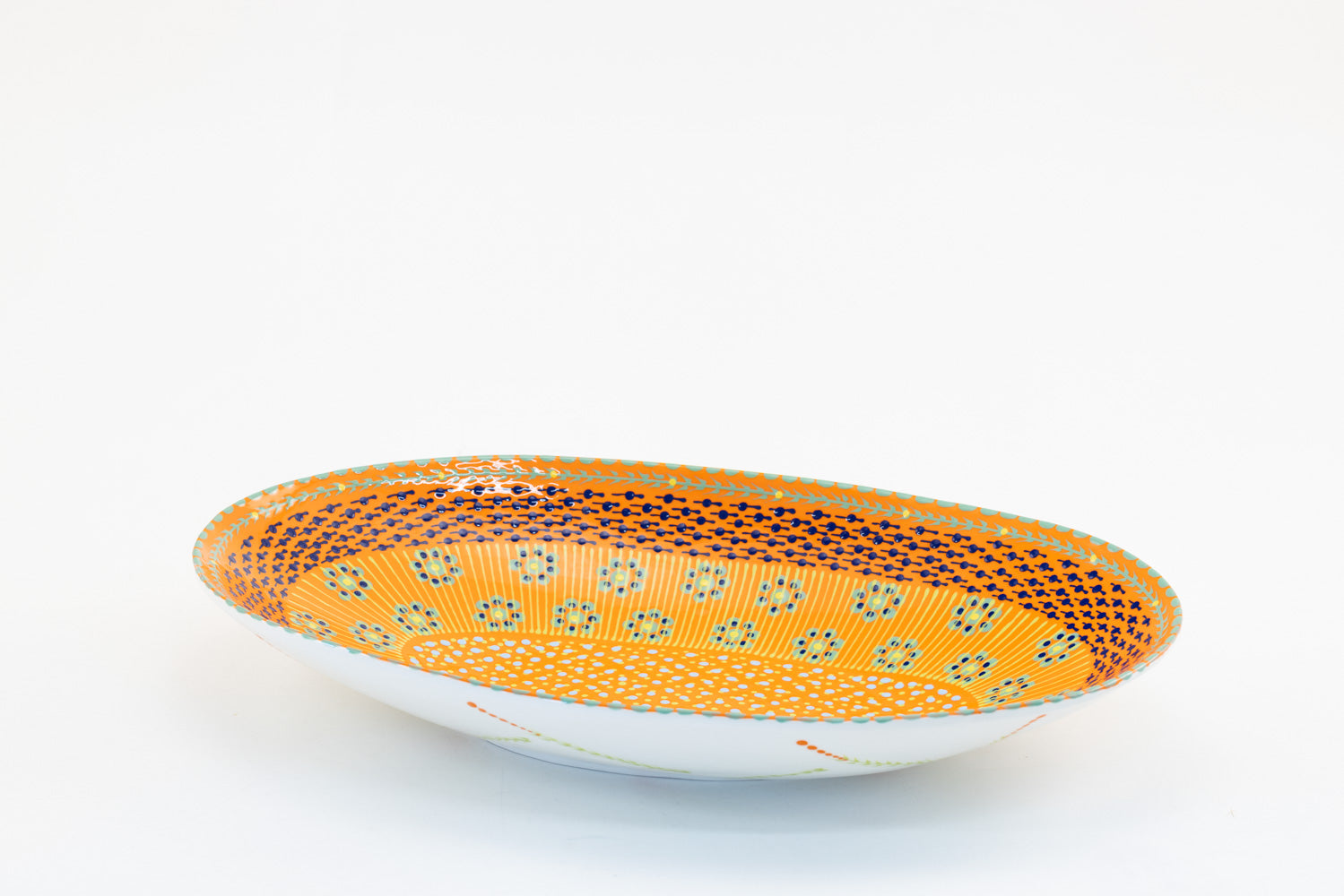 Orange large oval serving bowl with dots, stripes and small flowers painted in baby blue, lime green and yellow. 15" x 8".  Great to top off any table!
