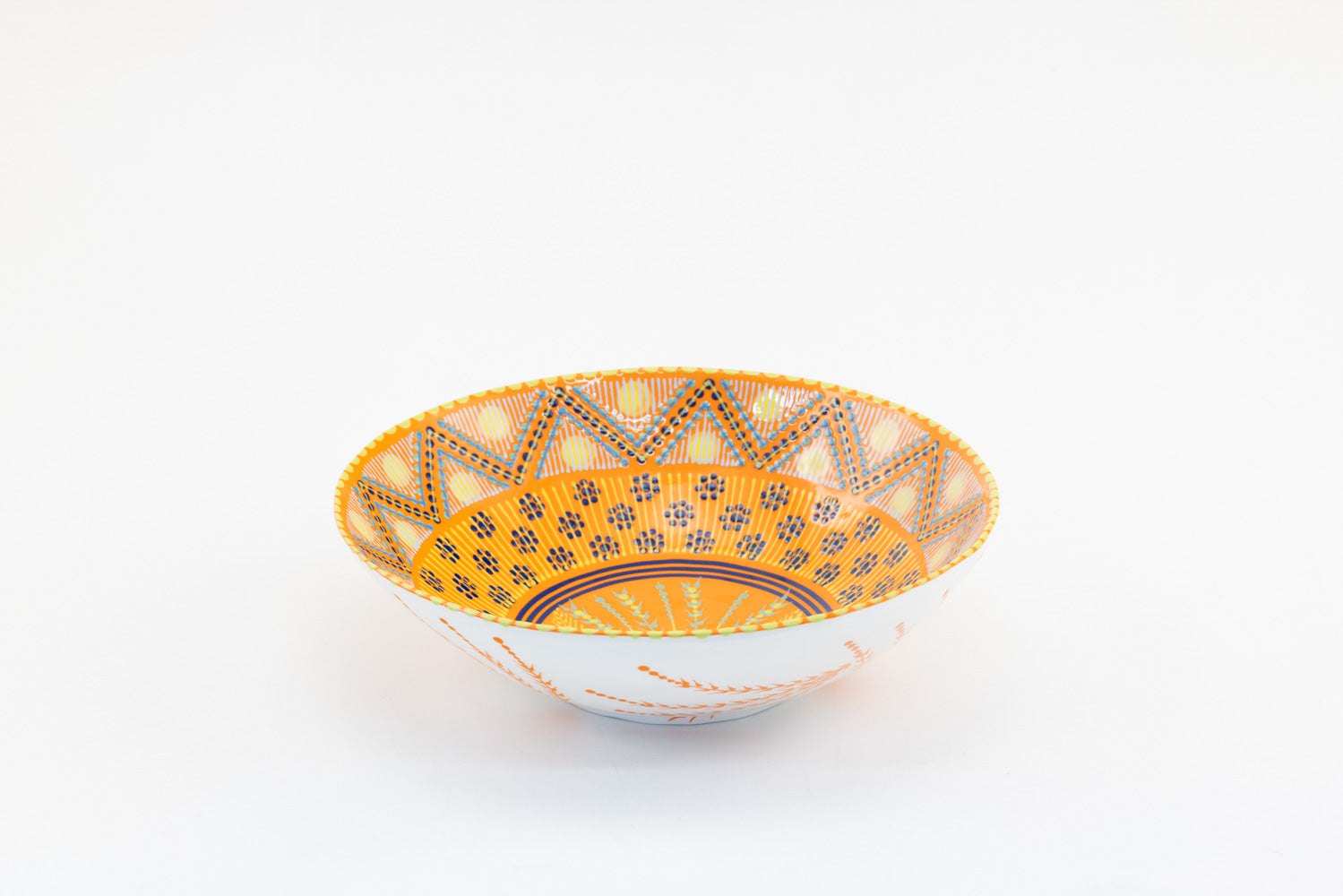 Orange large round ceramic serving bowl. 11"x 3".  Orange inside background, painted in floral pattern with yellow, lime green,  and baby blue.  White outside with orange accent design. Microwave & Dishwasher safe.