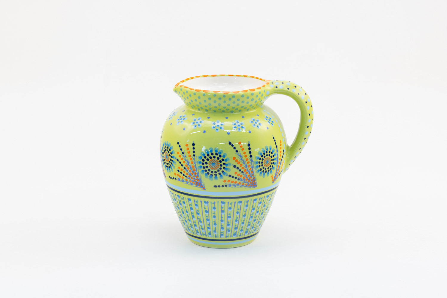 Classic water jug with background color of lime green.  Dots, stripe and flowers make the colorful designs on the background colors. 9" tall x 5" wide.