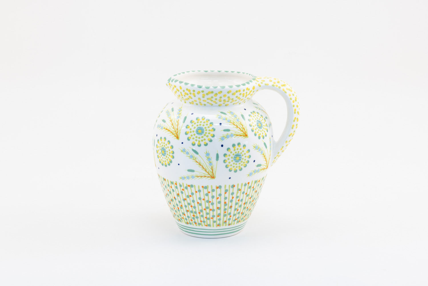 Classic water jug with background color of white.  Dots, stripe and flowers make the colorful designs on the background colors. 9" tall x 5" wide.
