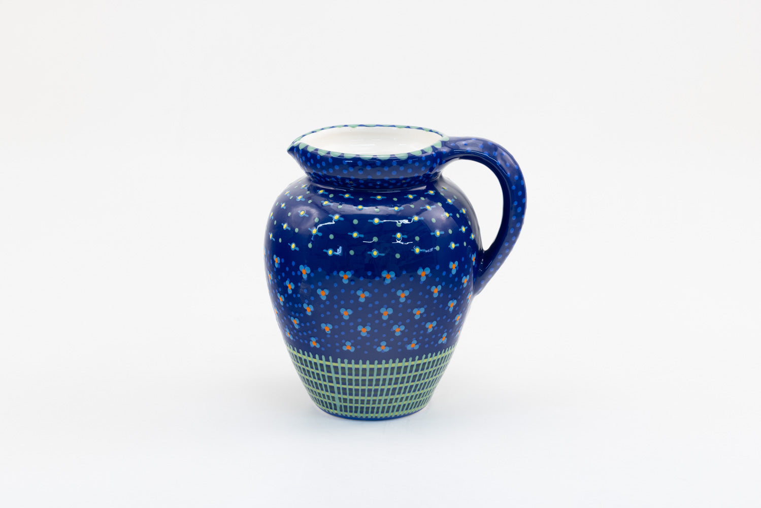 Classic water jug with background color of indigo blue.  Dots, stripe and flowers make the colorful designs on the background colors. 9" tall x 5" wide.