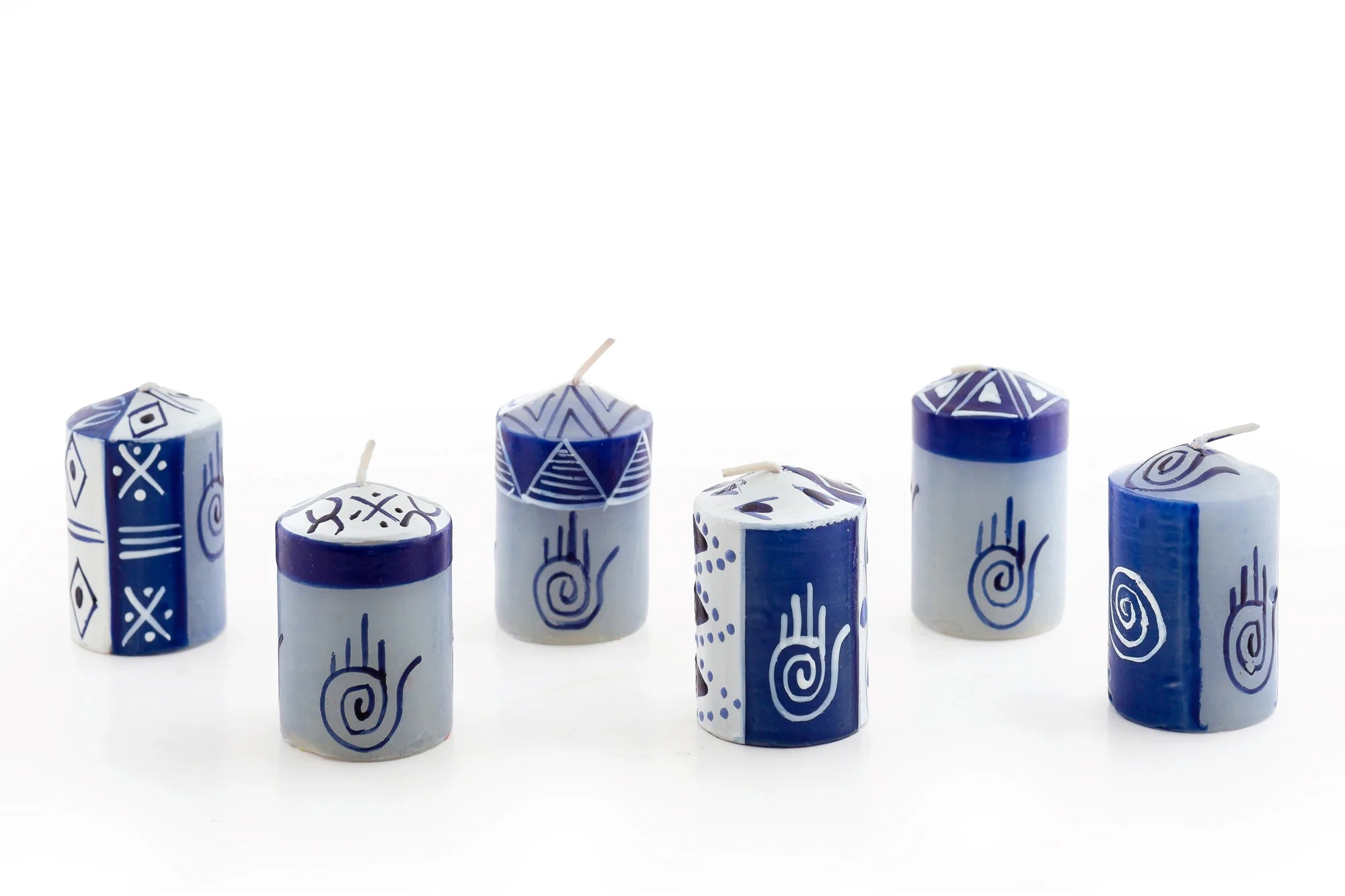 6/ 2" Hamsa votive candles painted in blue & white geometric designs with the Hamsa Hand included in the design