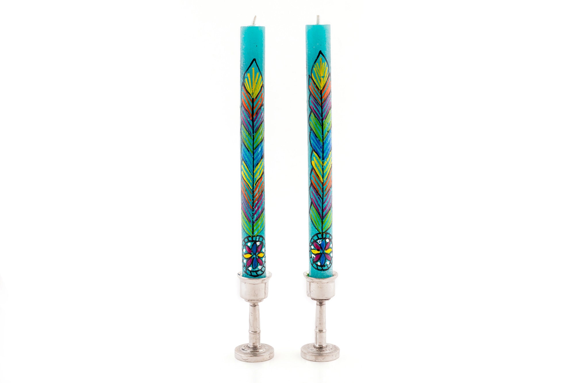 Hippie taper pair of turquoise candle with colorful flower painted up the taper - sitting in pewter taper holders.
