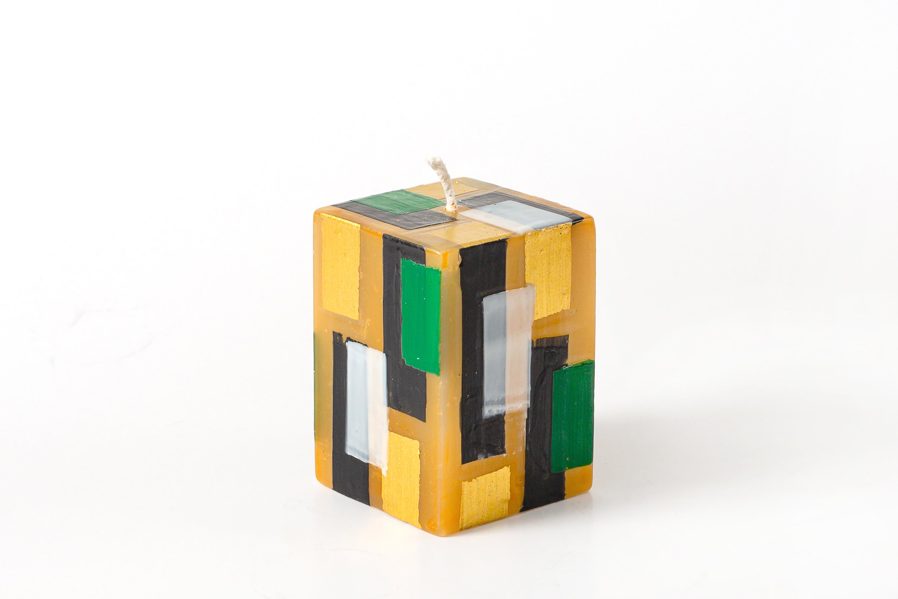 Klimt 2x2x3" cube candle. Creamy gold base color candles with touches of black, gold along with hints of green.