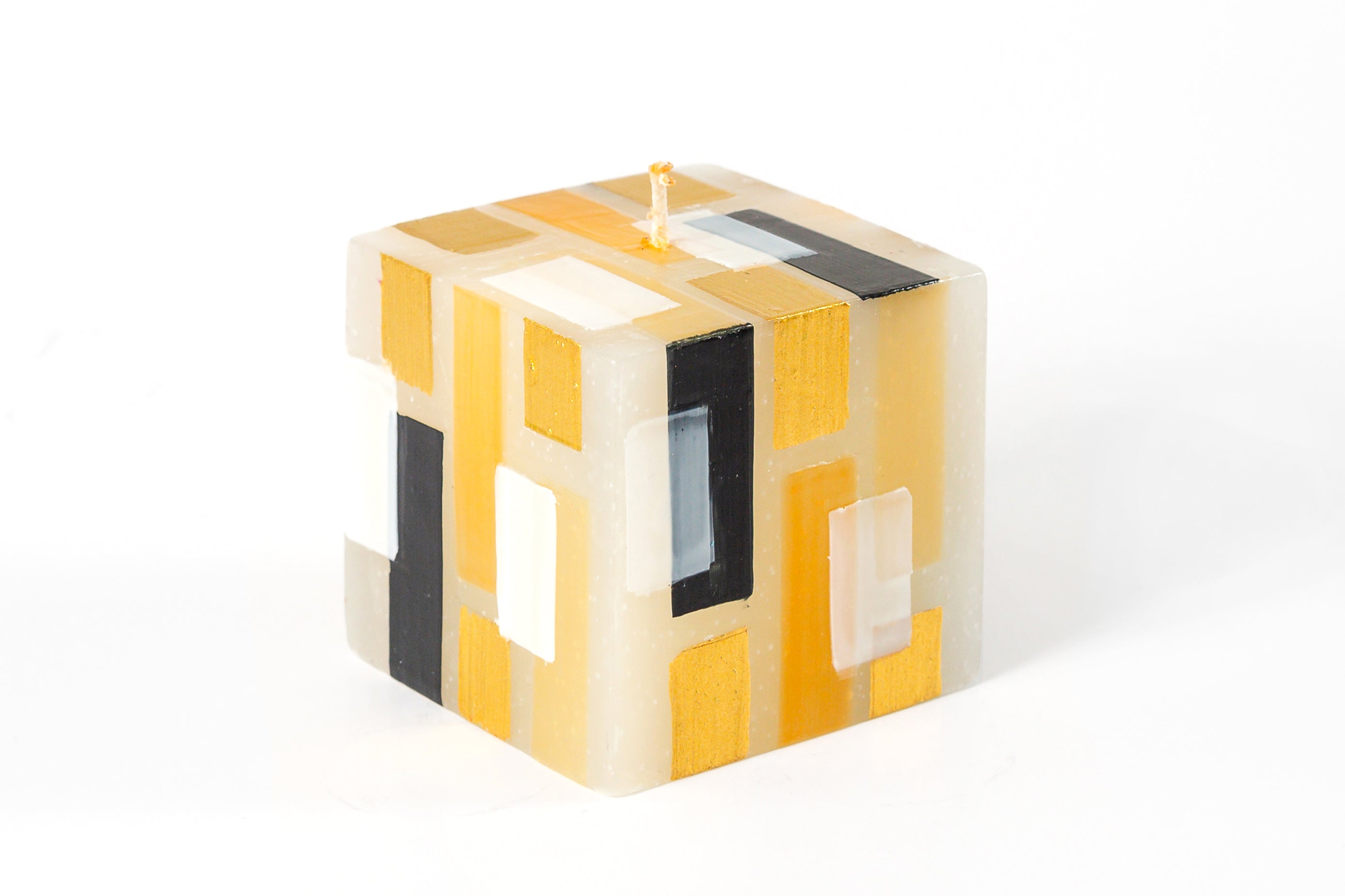 Klimt 3x3x3" cube candle. Creamy white base color candles with touches of black, gold and white.