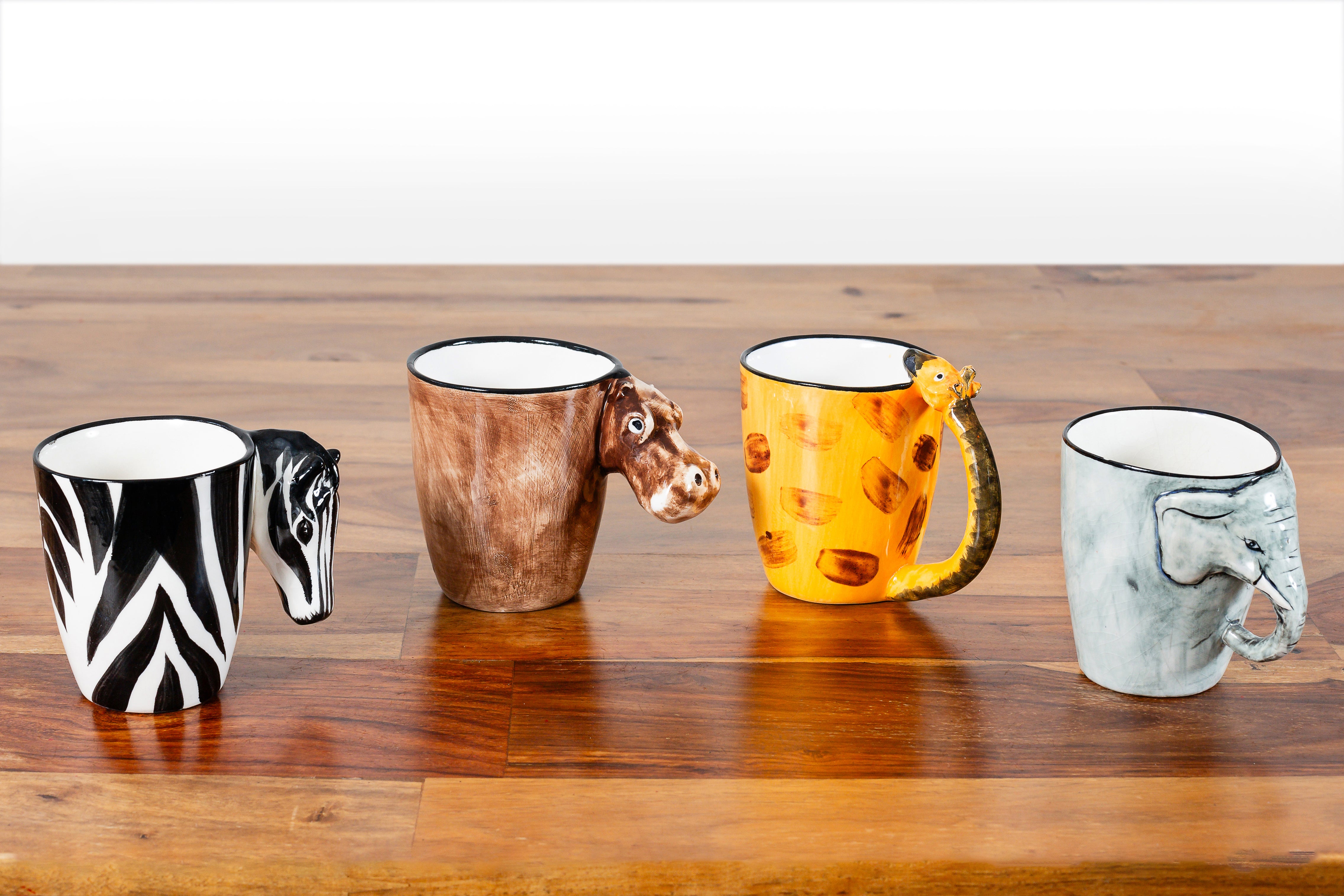 Collect all 4 of these animal mugs, from left, zebra, hippo, giraffe, and elephant!