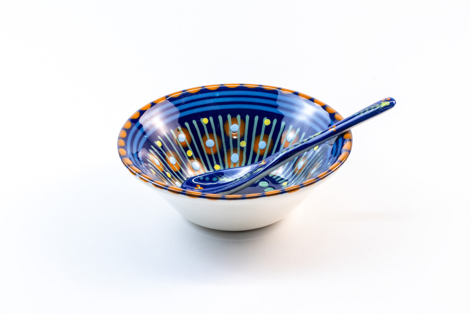 ndigo blue ceramic mini nut bowl with matching ceramic small spoon in Indigo Blue. Dots & Stripes on top of base color in orange, yellow, & turquoise and green. Perfect pair!