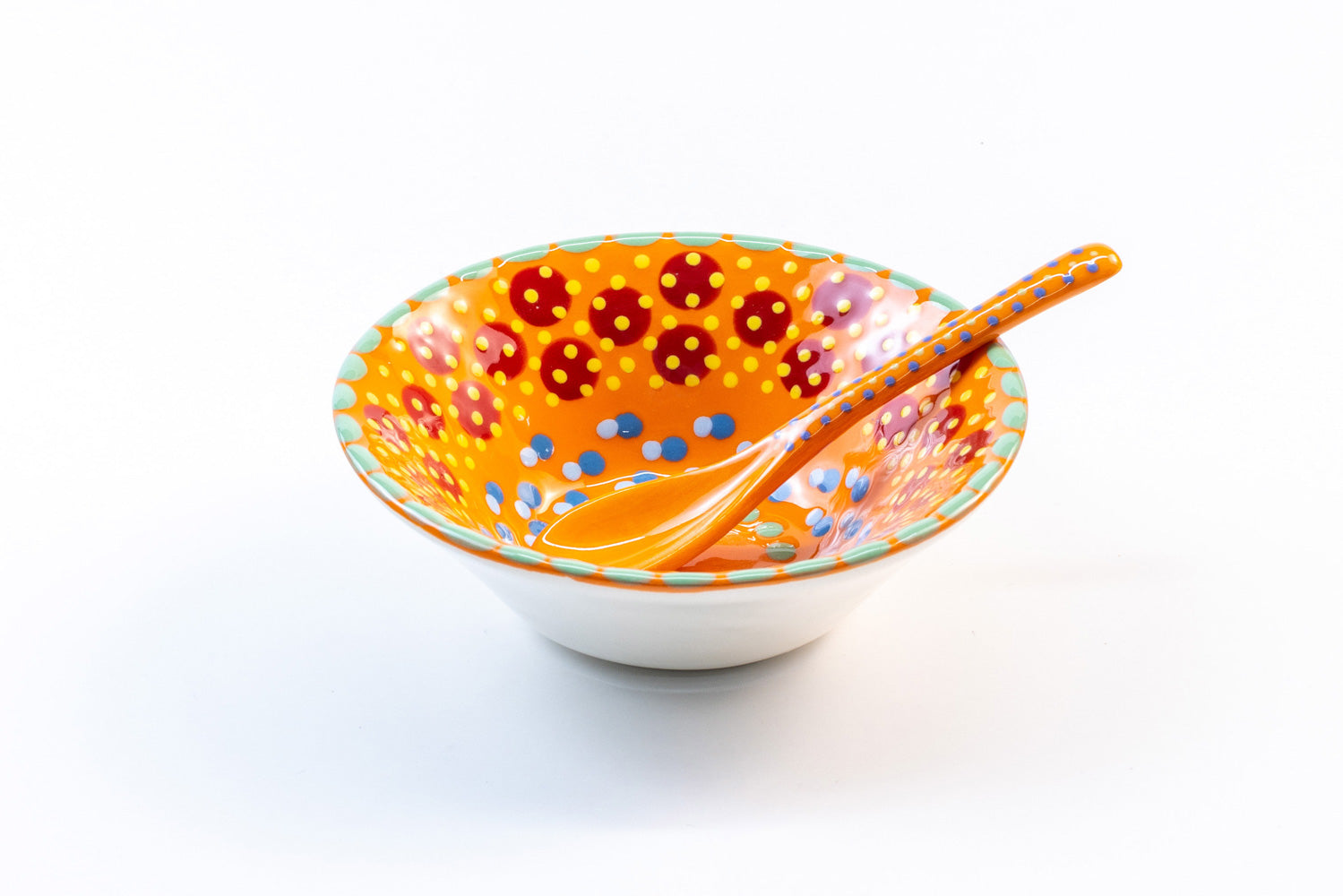 Orange ceramic mini nut bowl with matching ceramic small spoon in orange. Dots & Stripes on top of base color in turquoise, red, yellow and green. Perfect pair!