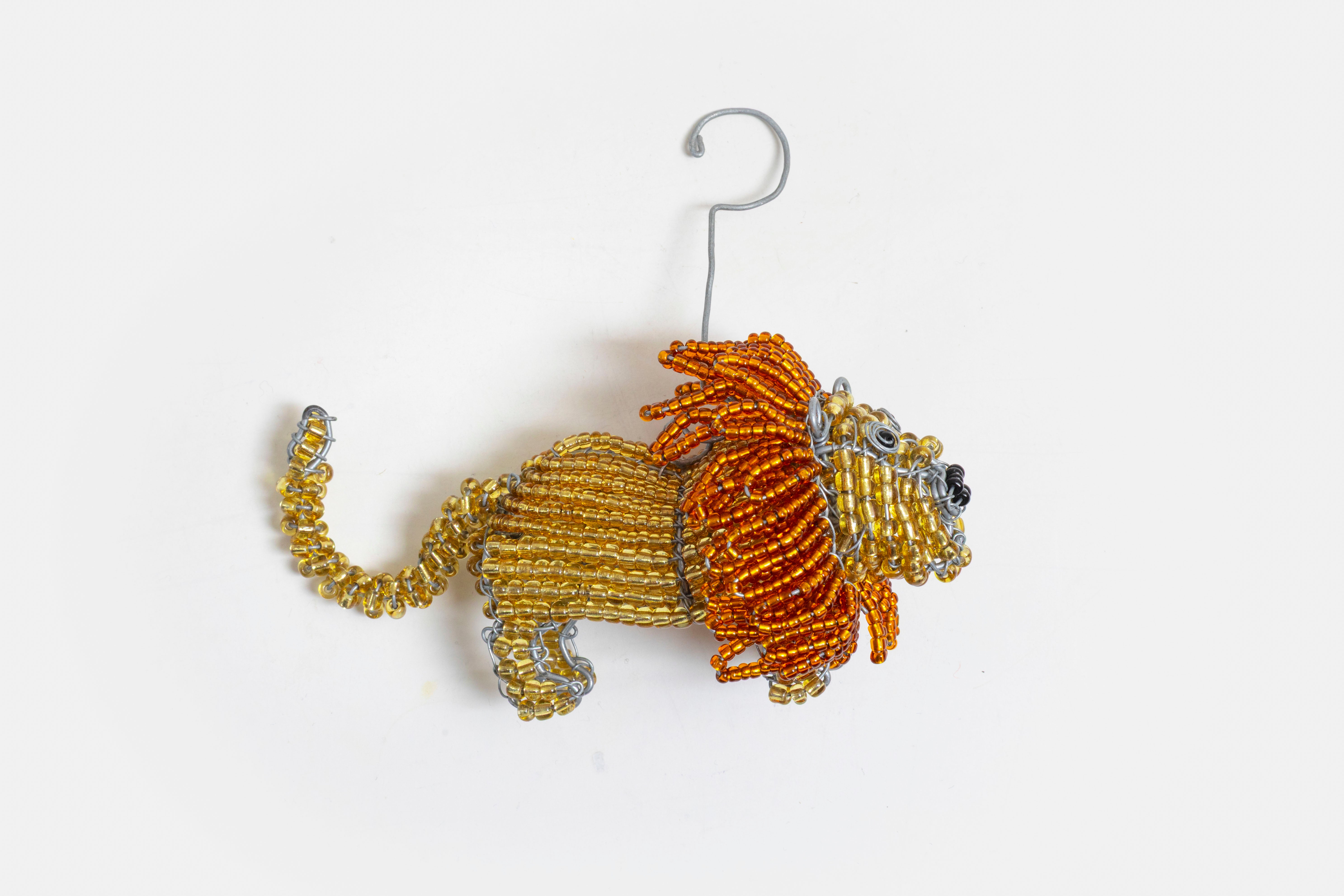 Hand made Beaded Lion ornament!  Hanging hook attached behind the mane.  Mustard yellow with a golden mane.   Great addition to a Christmas Tree!