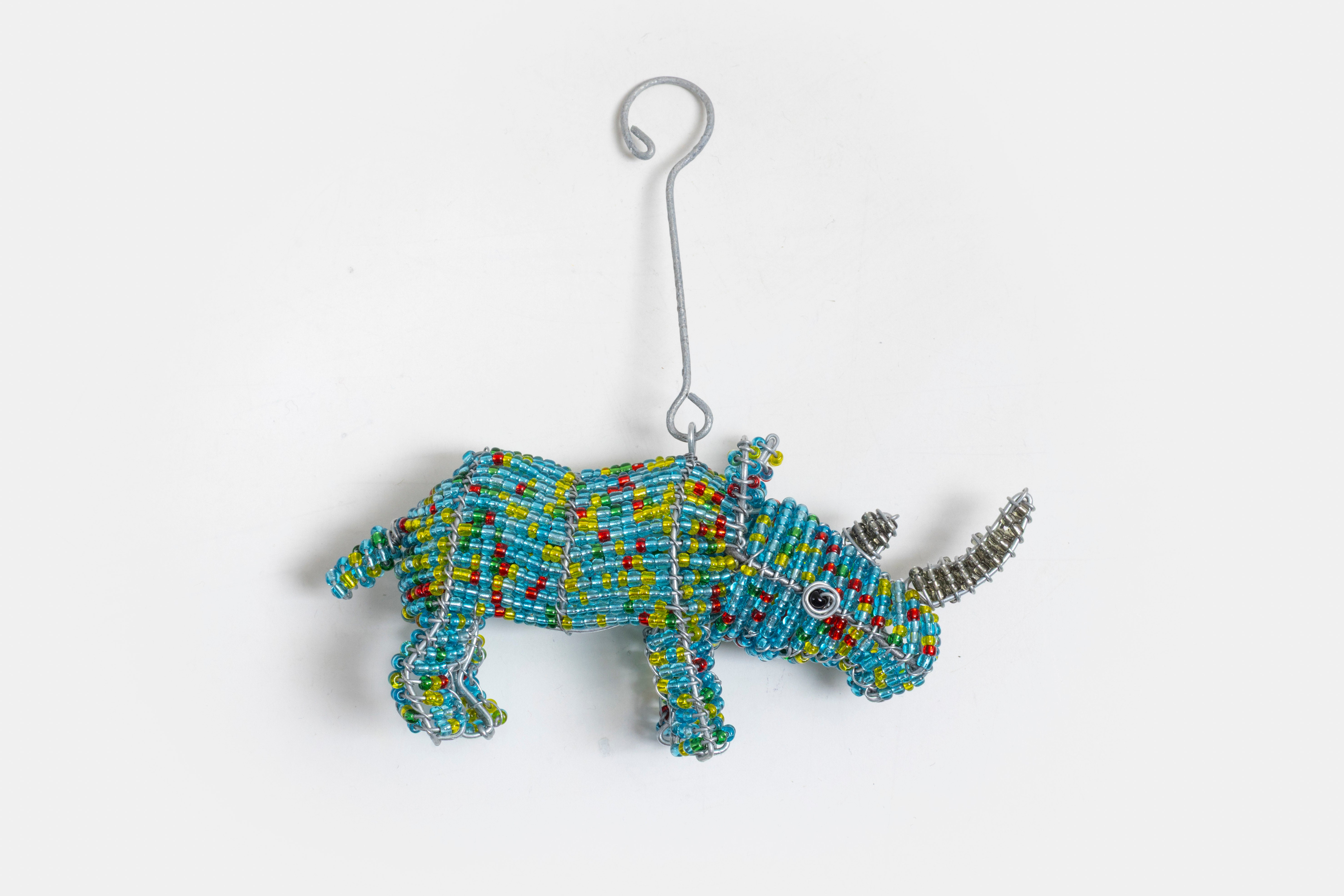 Hand made Beaded Rhino ornament!  Hanging hook attached behind the ears.  Comes in many colors.   Fun addition to the  Christmas Tree!