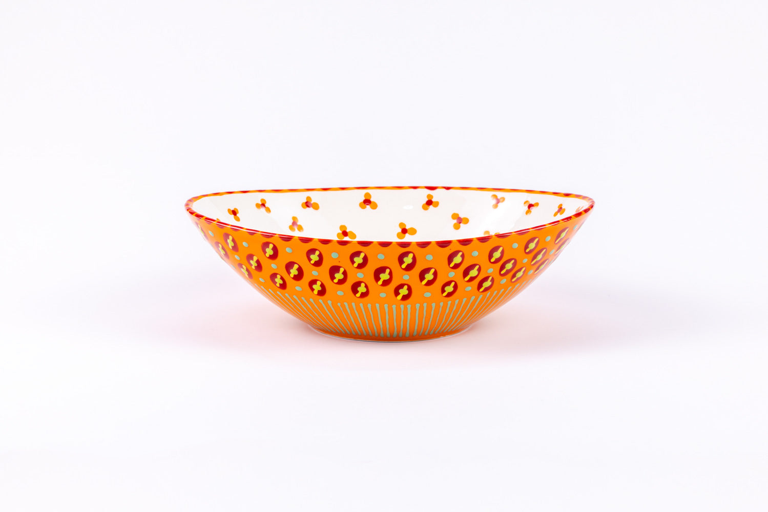 Oval ceramic serving bowl with orange base color. Red, yellow, and green dots & stripes on top. Inside is white with orange & red 'dot' flowers. Very fun and fairly traded.!