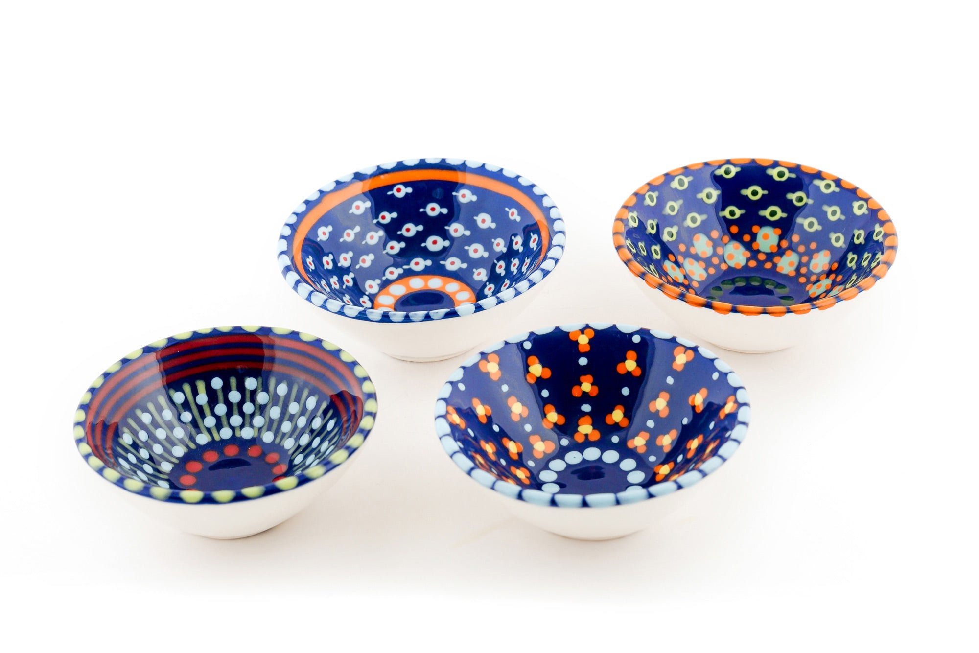 4 Indigo tiny bowls.  Indigo blue base color with variations of the designs on the blue in read, orange, yellow, baby blue and jasper green.  