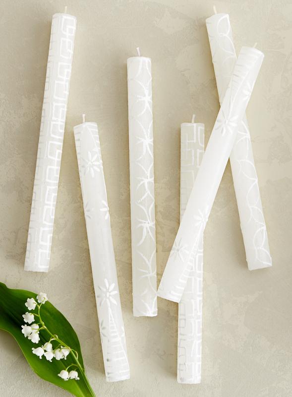 White on white dinner tapers. White candles with designs painted on in white - beautiful as they burn!
