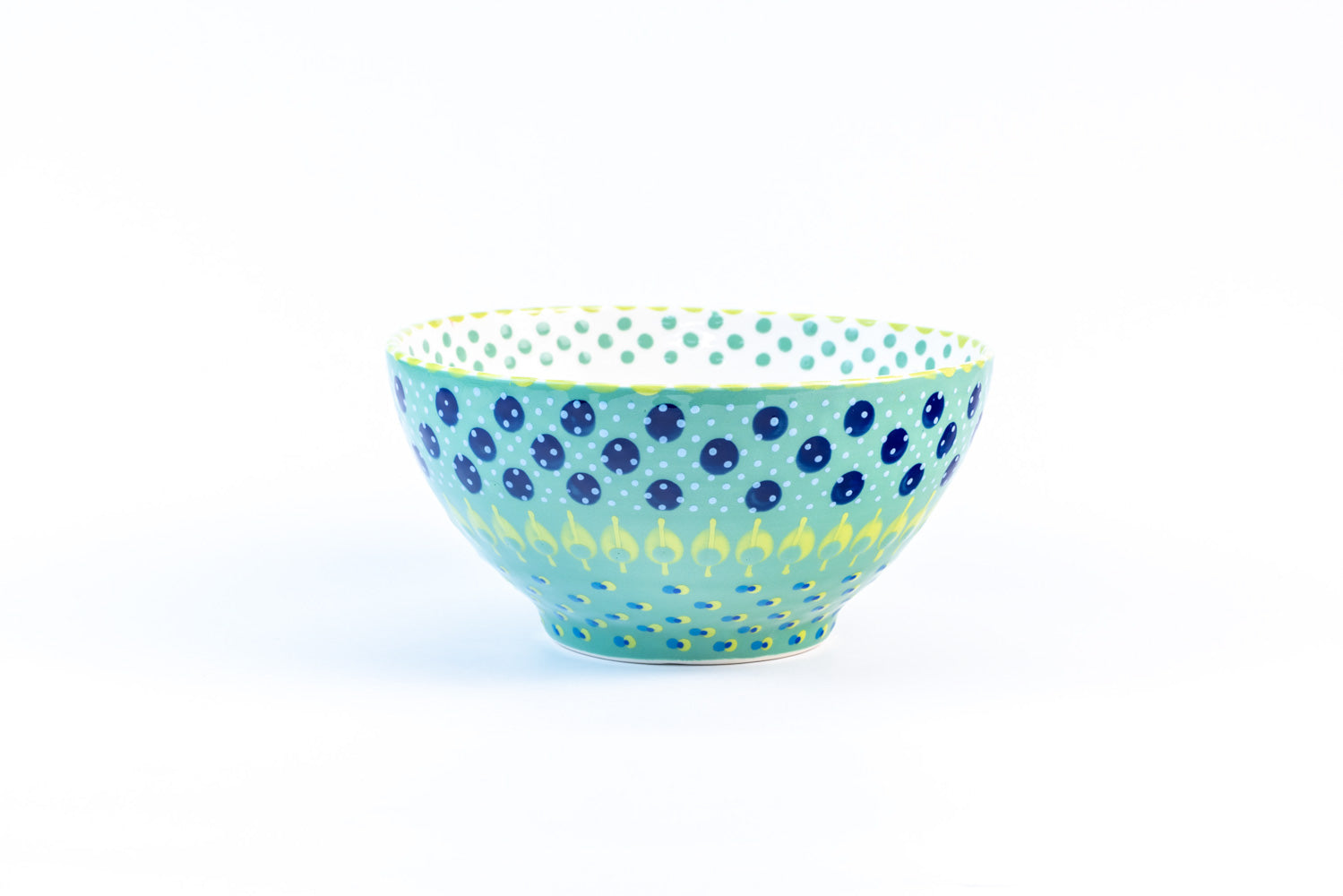 Ceramic serving bowl with base color of Jasper Green.  Blue. Dots & Stripes painted on top in fun colors of yellow, turquoise, orange & red. White inside the bowl.