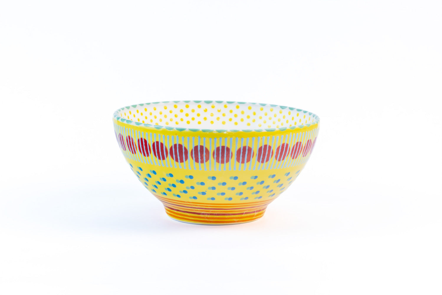 Ceramic serving bowl with base color of Yellow. Dots & Stripes painted on top in fun colors of turquoise, orange, green  & red. White inside the bowl.