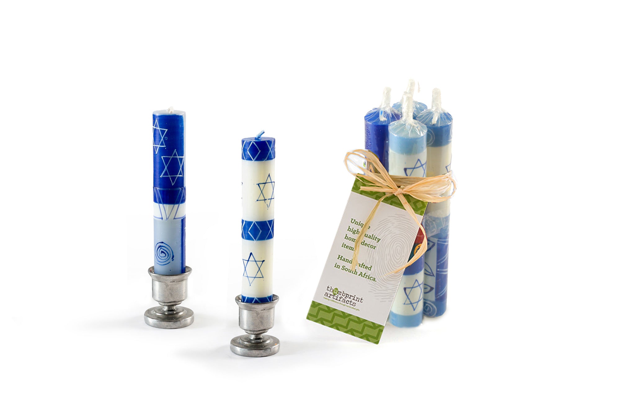 A pair of Star of David Shabbat candles in pewter taper holders, with a pack of 4 tied together with a story card showing how these candles are sold in a gift pack.