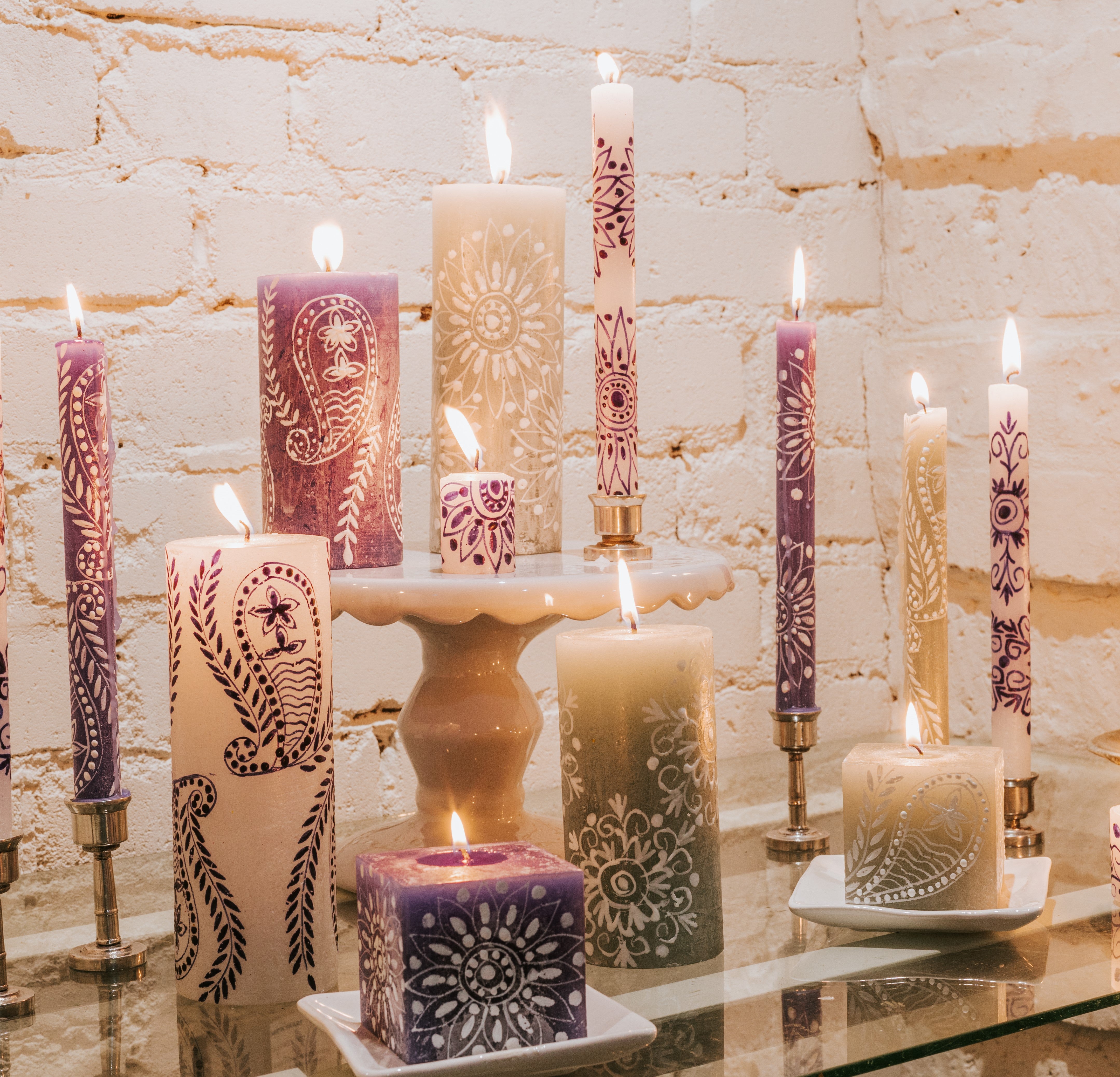 Lifestyle photo of Henna White on Blue pillar, tapers, and cube, mixed with Henna Duck Egg pillars & cube and Henna Blue on White pillar & tapers- all burning brightly!  Great to mix and match!