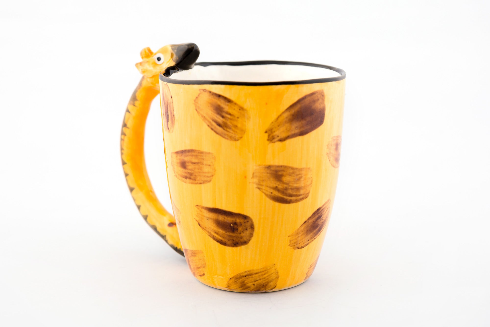 Reverse side of the ceramic coffee mug with a Giraffe neck for the handle and his head resting on the lip of the mug. Painted in giraffe skin colors of yellow & brown with white inside the mug.