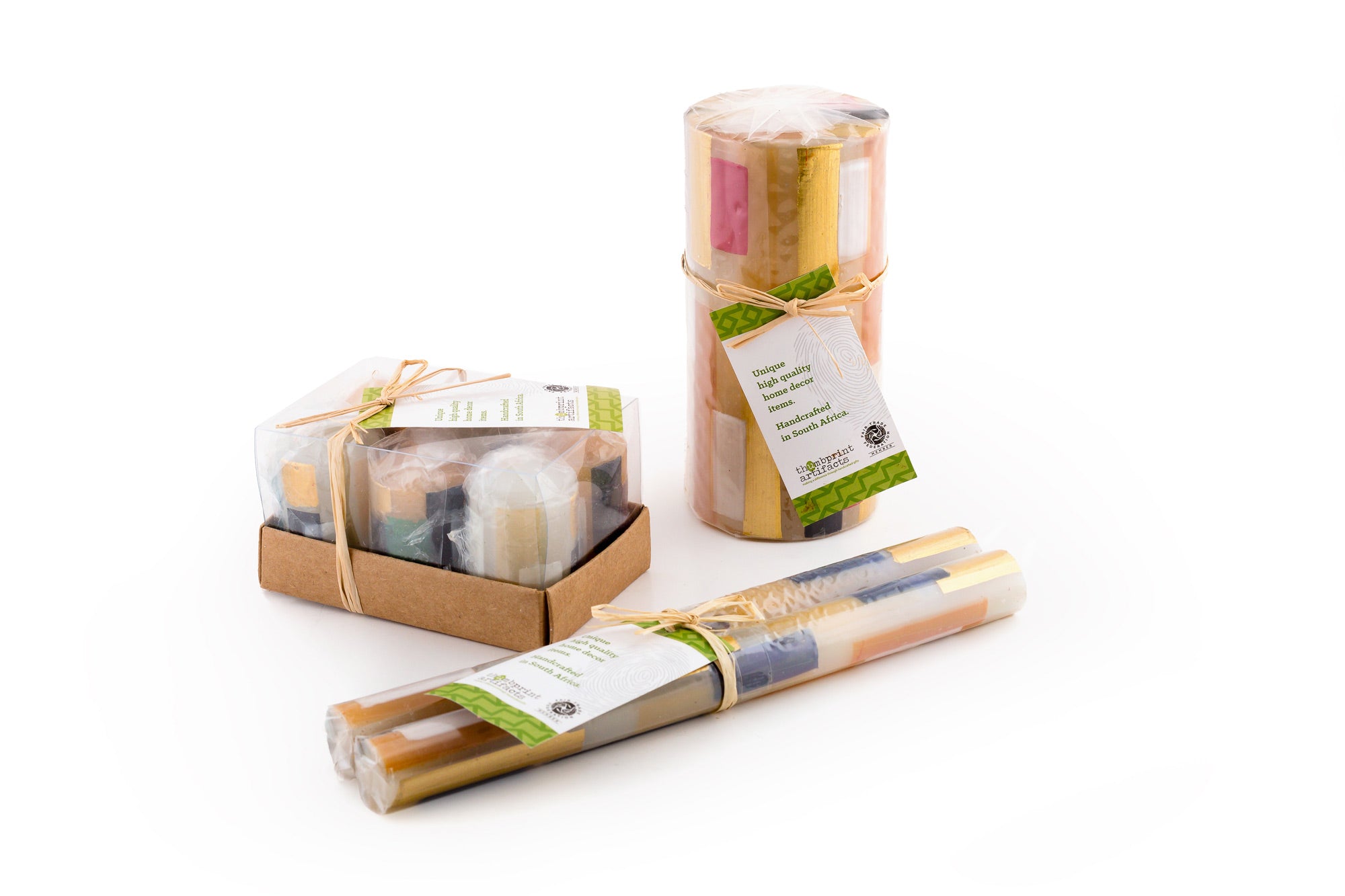 Photo of how the candles are packaged; tapers individually wrapped in matched pair, pillars & cubes are wrapped, and votives come individually wrapped in a 6-pack.  All in sustainable packaging and with a story card.