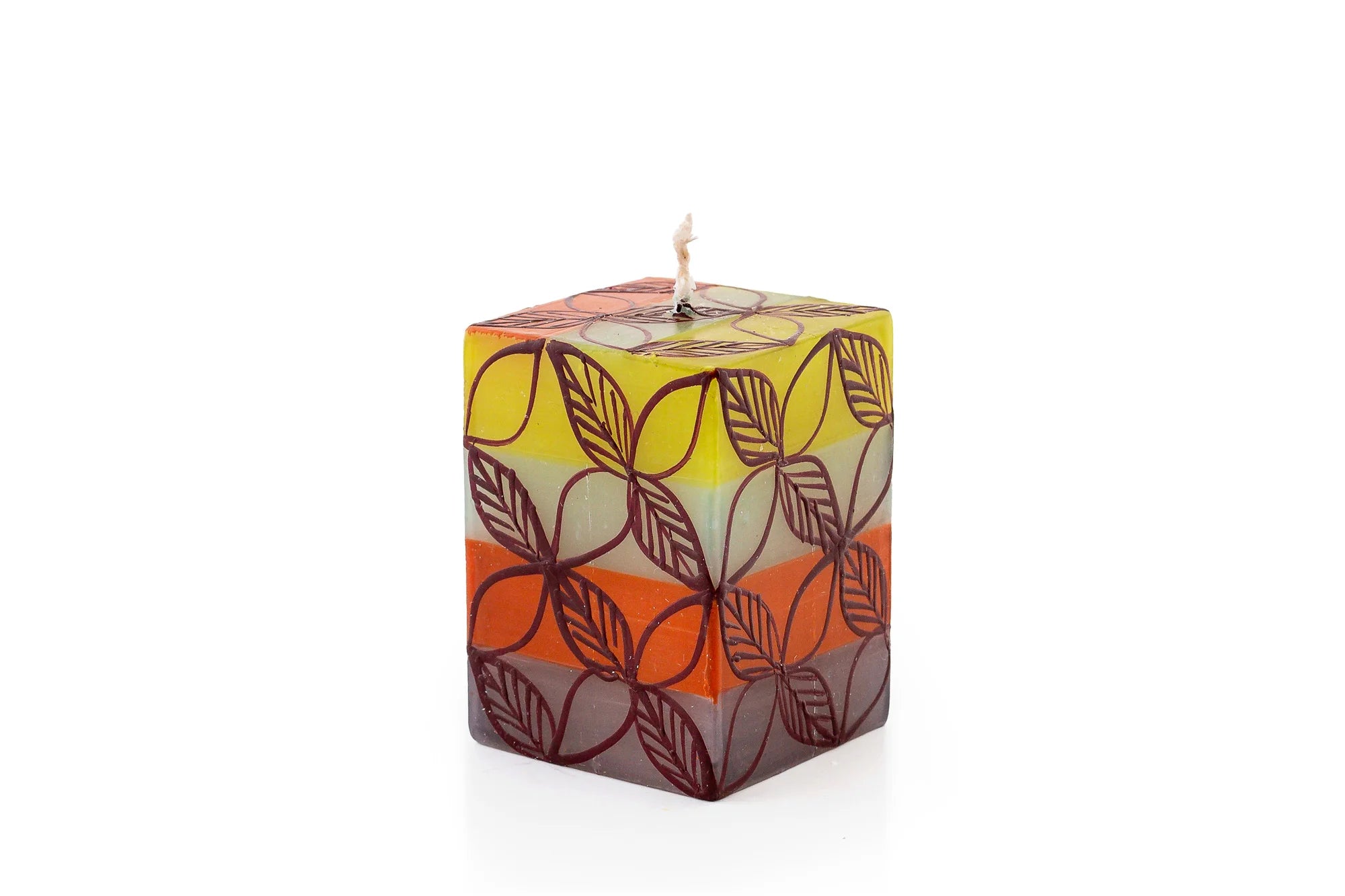 Magic Garden 2" x 2"x 3" cube candle. The cube is a white base with green, orange, turquoise, and lavender stripes. Overlay of pigment colors with a variety floral and leaf designs.