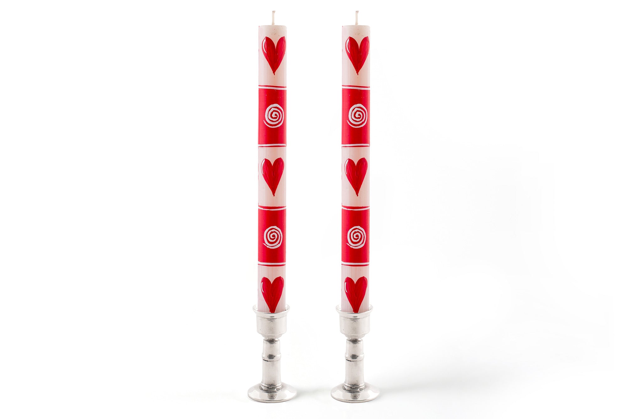 Valentines hand painted matched taper pair in thick pewter taper holders. Red & white  with whimsy hearts, dots, and circle graphics.  Fair trade home decor. 