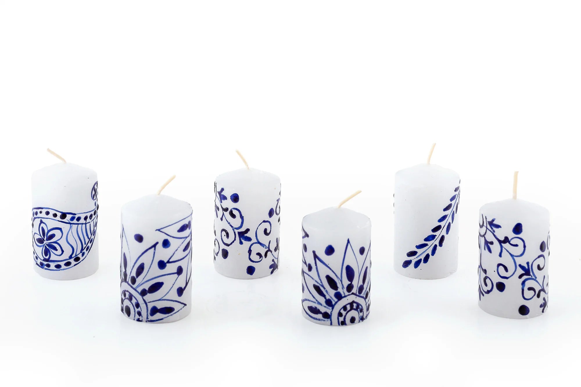 Henna Blue on White 6 2" votives.  The blue henna design is painted on white candles. The 6 votives come in a 6-pack gift box.