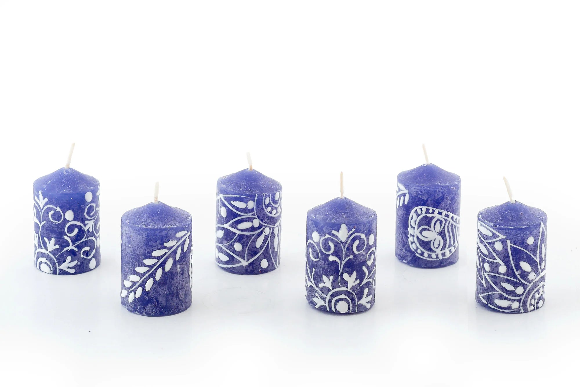 6 Henna white on blue 2" votives.  Henna designs painted in white on blue candles. These 6 votives come in a 6-pack gift box.