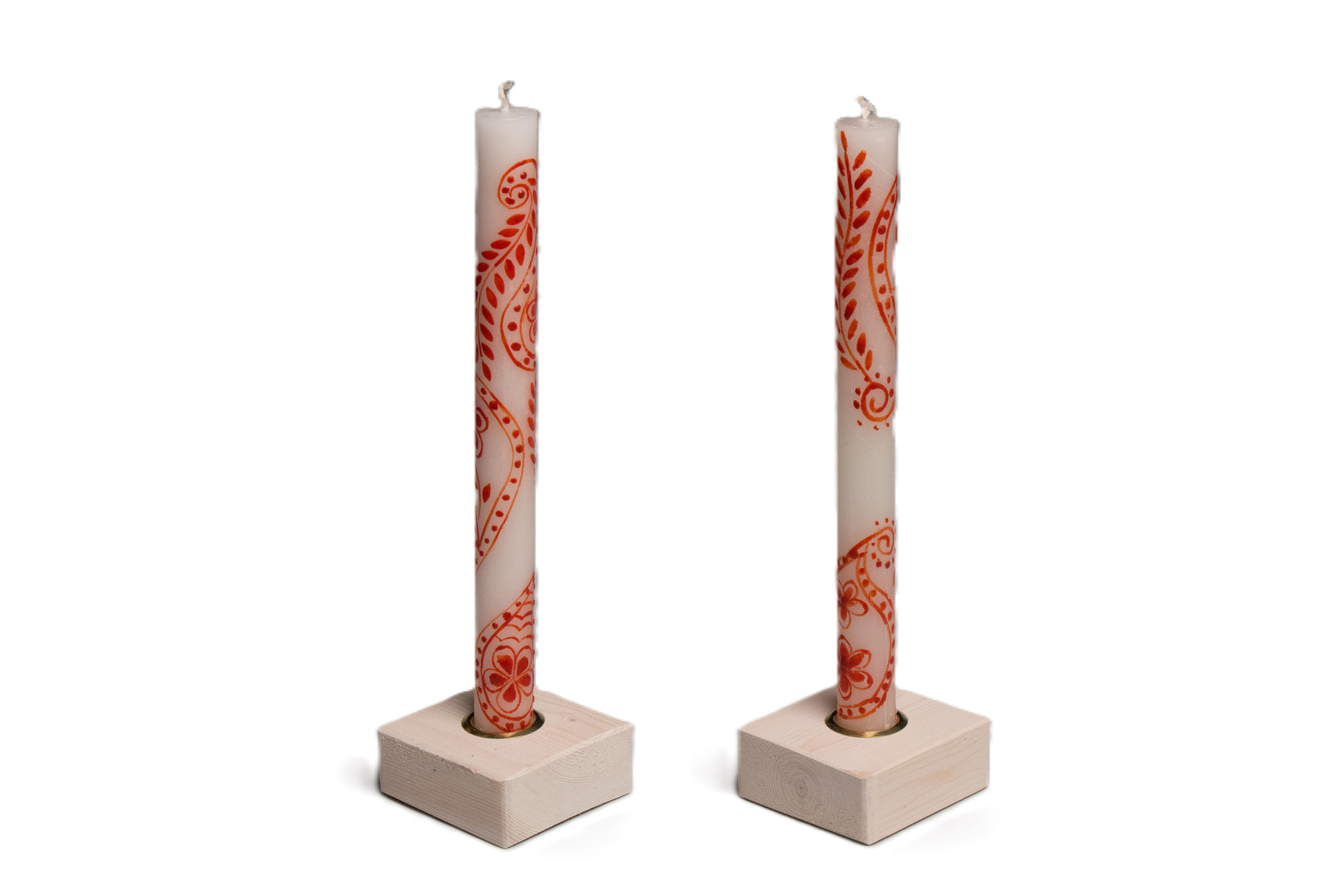 White wash color taper candle holders holding a pair of Henna Red on White taper candles.