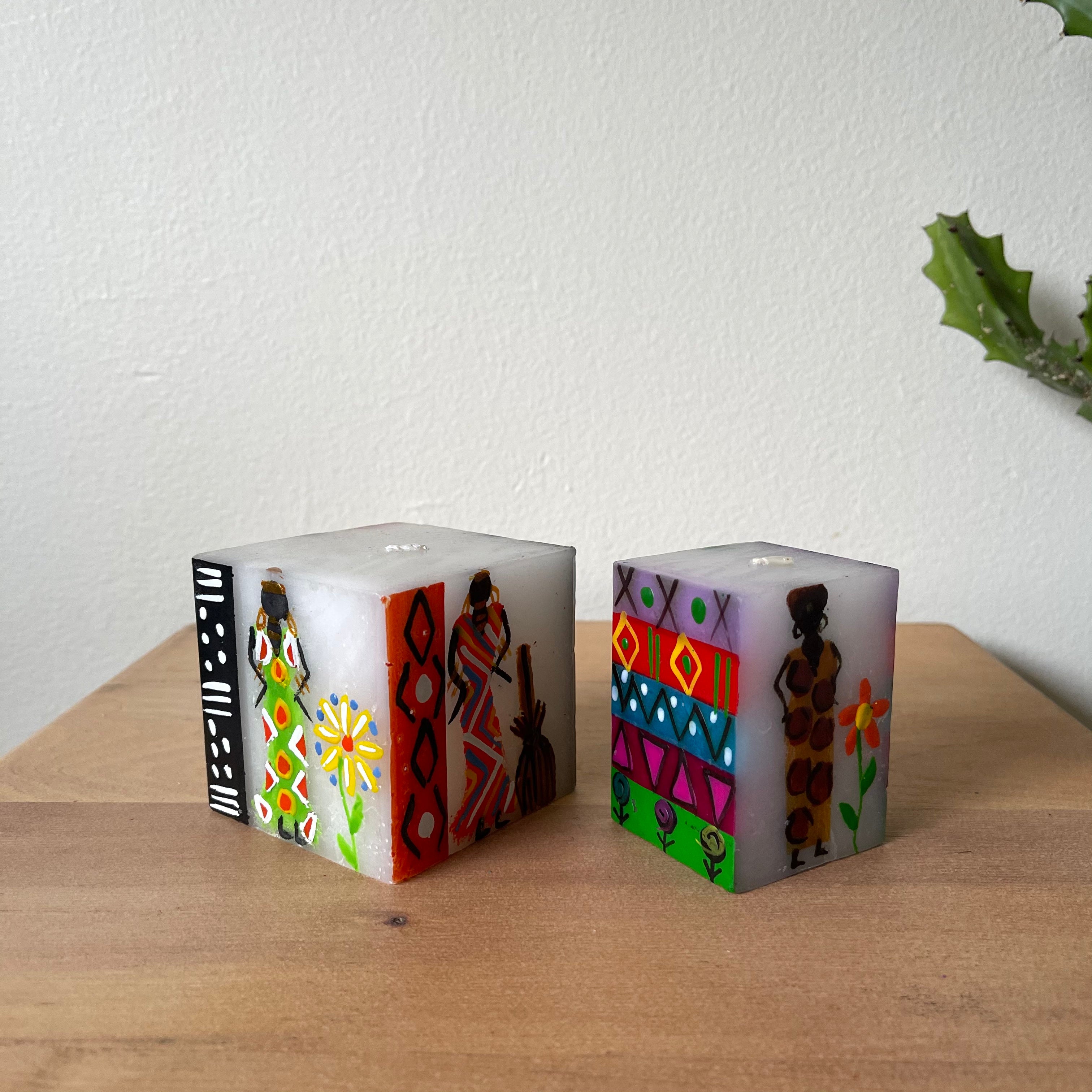 Two African Ladies cubes, 3x3x3 and 2x2x3.  Colorful design with whimsy African Lady painted on the side.