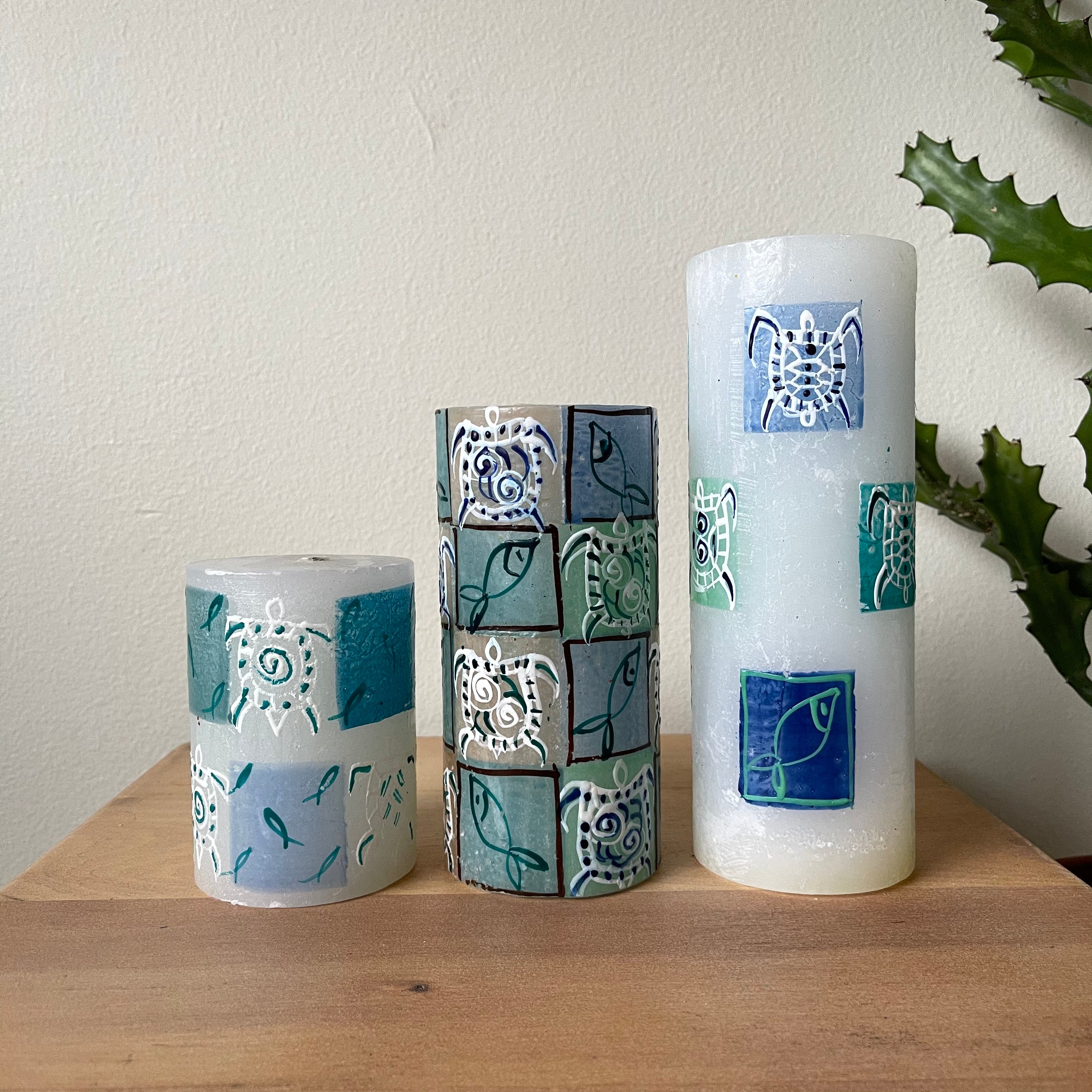 Three Arniston pillars, 3"x4", 3"x6", and 3"x8".  White background with pictures of turtles and fish painted on the sides. Fair Trade.