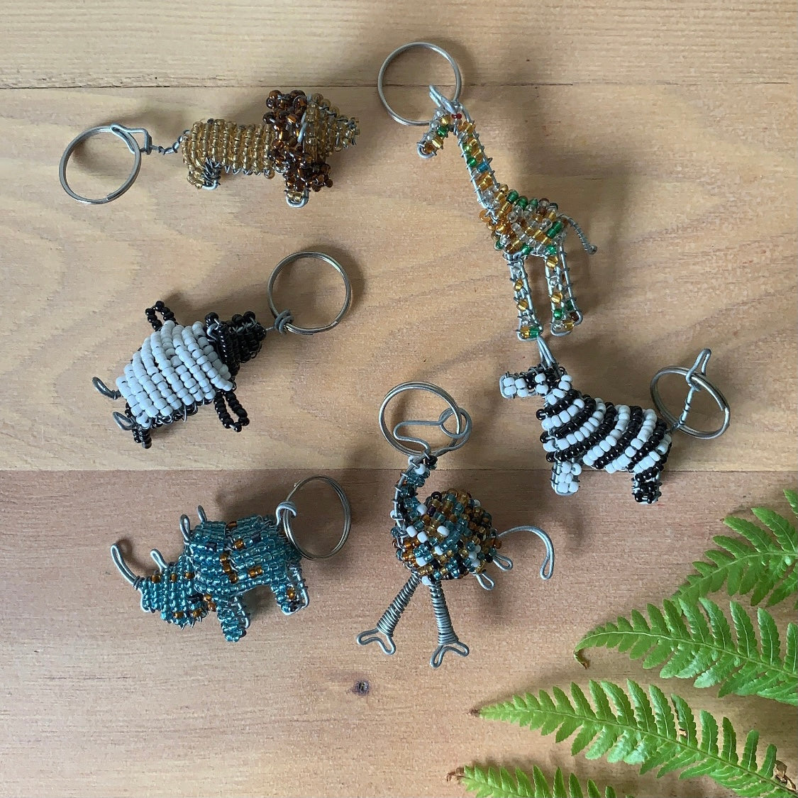 Small beaded key chains; lion, giraffe, zebra, ostrich, rhino, and penguin. Fair Trade products.