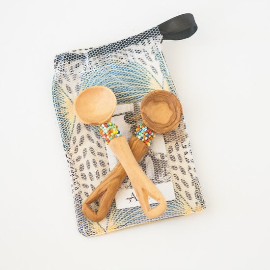 2 small wooden spoons with bead word around the spoon just under the round head presented in a gift pouch with story card.  Hand made, fair trade.