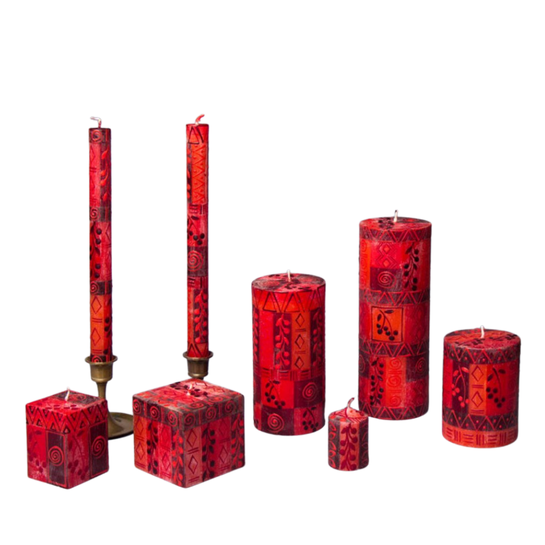 Berry Blaze hand made candle collection. Small and larger cube, taper pair, three pillars and votive.  All in reds and berry motif.  Fair Trade.