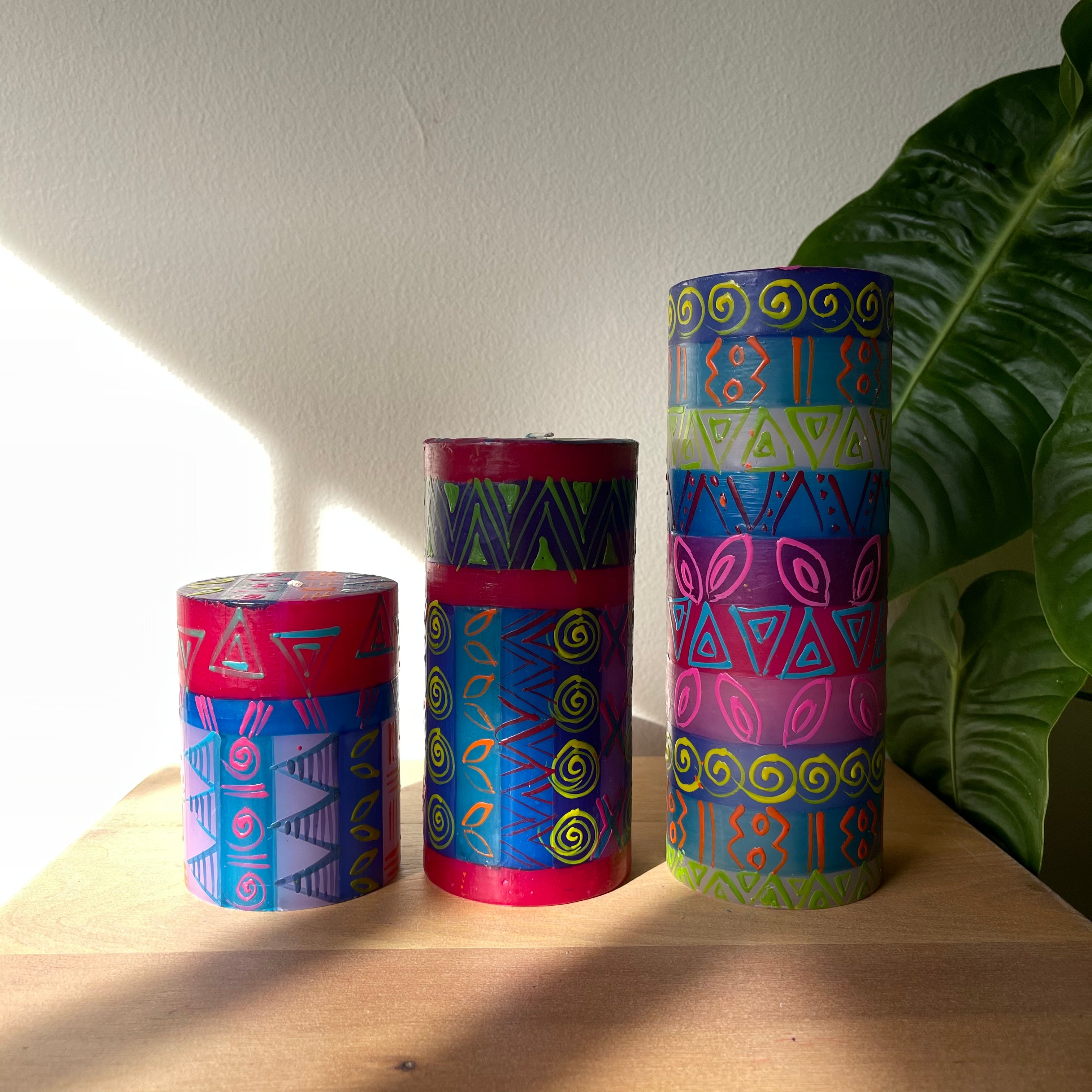Three pillar candles hand painted in the Blue Moon design; hews of blue, red, yellow and pink. 3" x 4", 3" x 6" and 3" x 8".